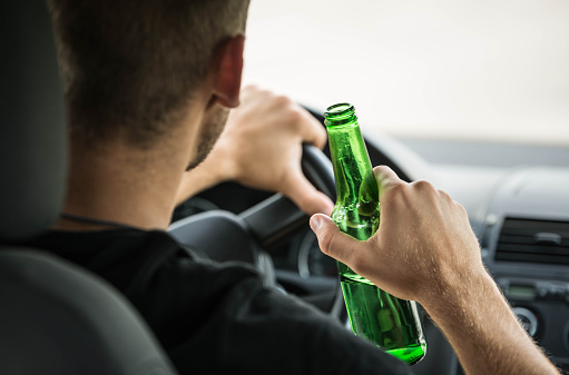 Teenager drinking beer while driving